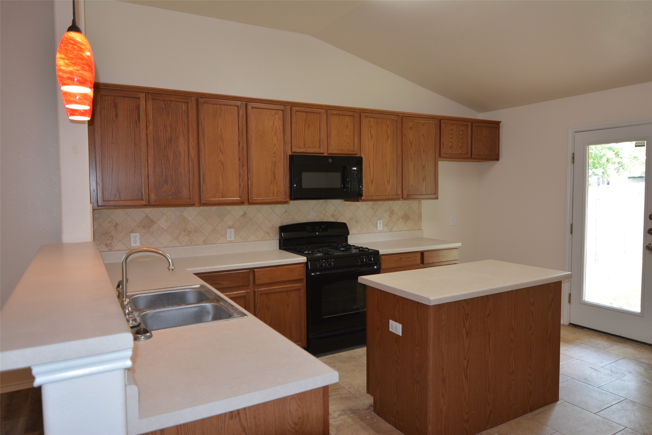 1303 Horseshoe Ranch Drive Leander, TX 78641 - Photo 7 of 26 A functional kitchen with wood cabinetry and a convenient center island awaits your culinary creations.