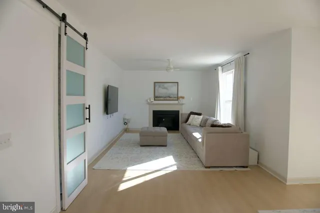 a living room with furniture a fireplace and a chandelier