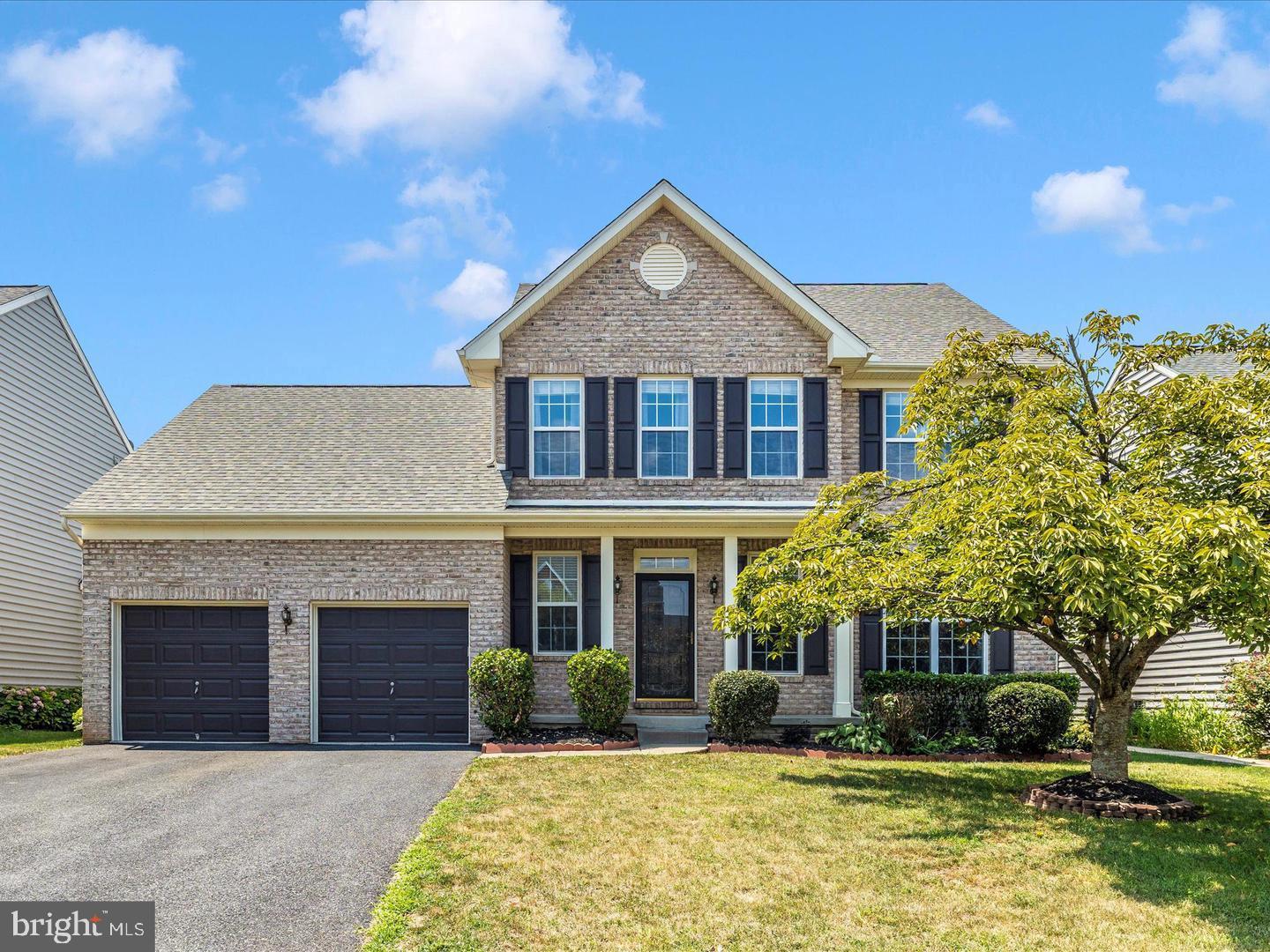 108 Wheeler Lane Frederick, MD 21702 - Photo 2 of 12 a front view of a house with a yard and garage
