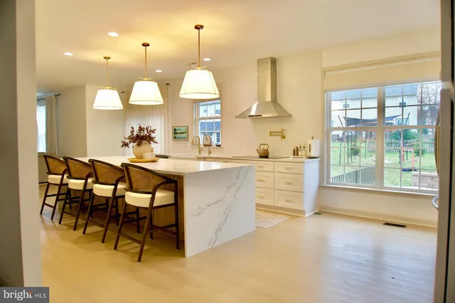 a kitchen with a sink a stove a dining table and chairs