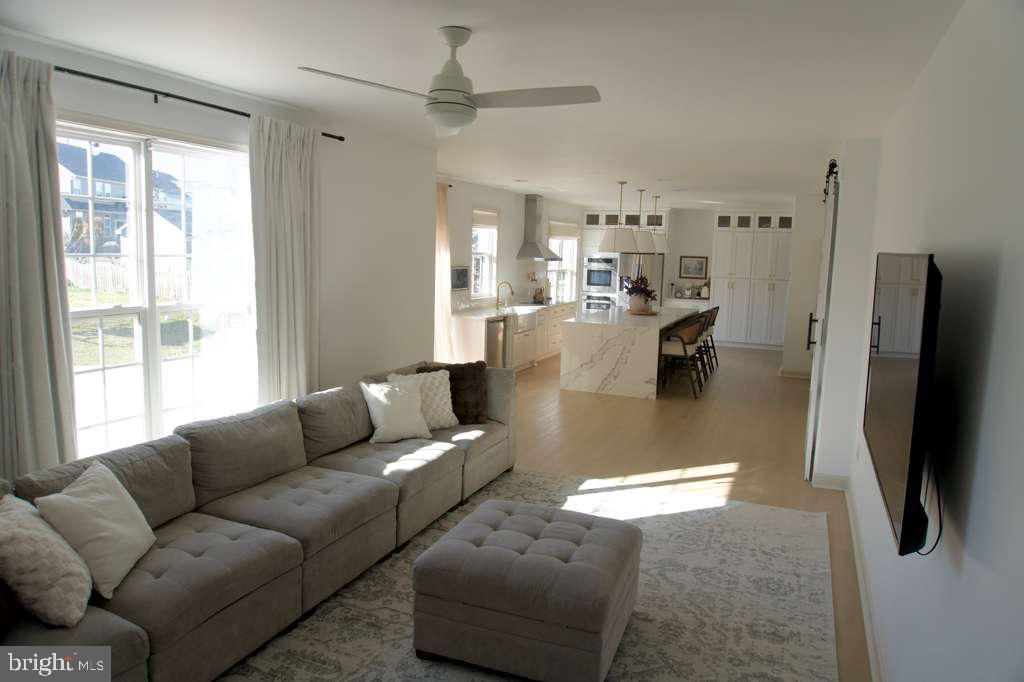 108 Wheeler Lane Frederick, MD 21702 - Photo 7 of 12 a living room with furniture and a flat screen tv
