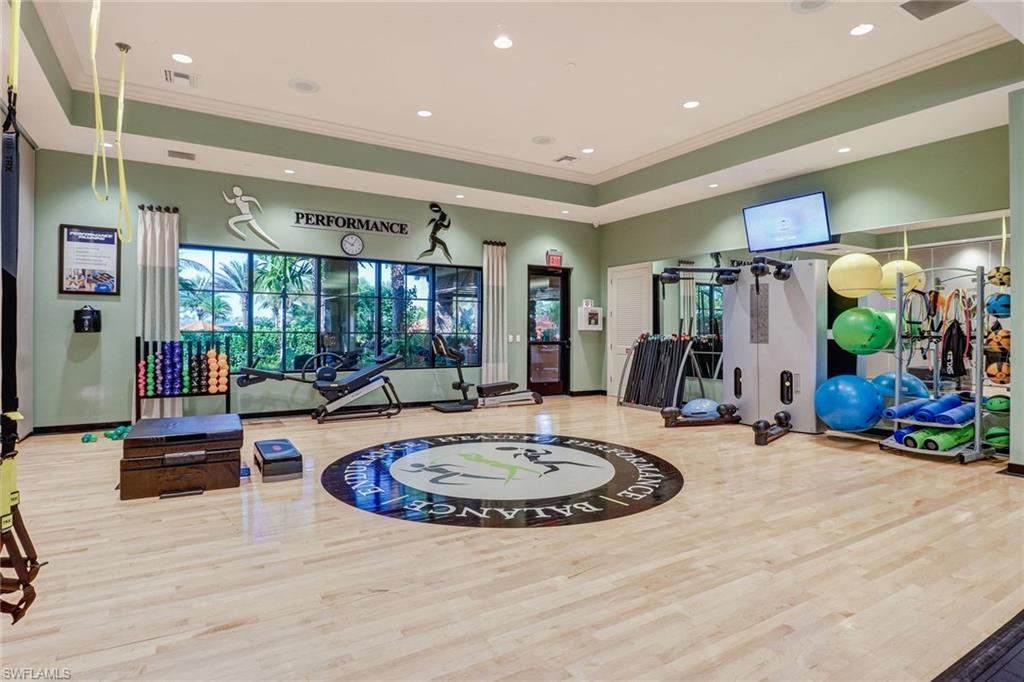 9366 Pocida Court, Unit 202 Naples, FL 34119 - Photo 40 of 44 a view of a living room and kitchen
