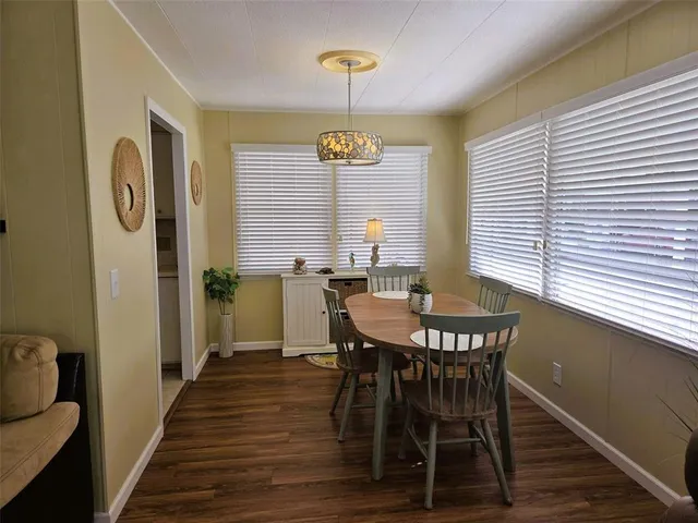 a kitchen with a refrigerator a stove a sink and cabinets