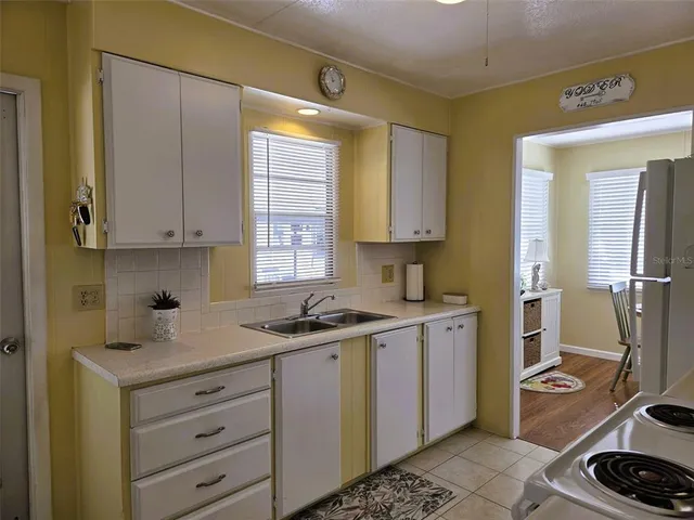 a kitchen with stainless steel appliances white cabinets and a refrigerator