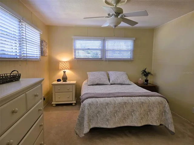 a spacious bathroom with a double vanity sink a mirror and a shower