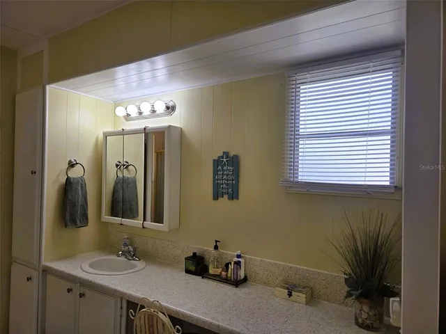 a spacious bathroom with a shower and a sink