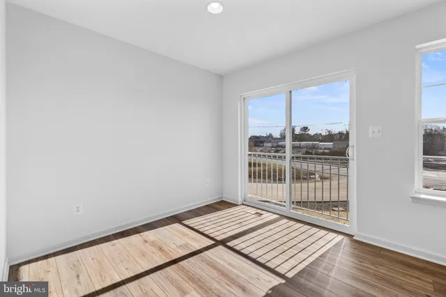 a view of a room with wooden floor and balcony