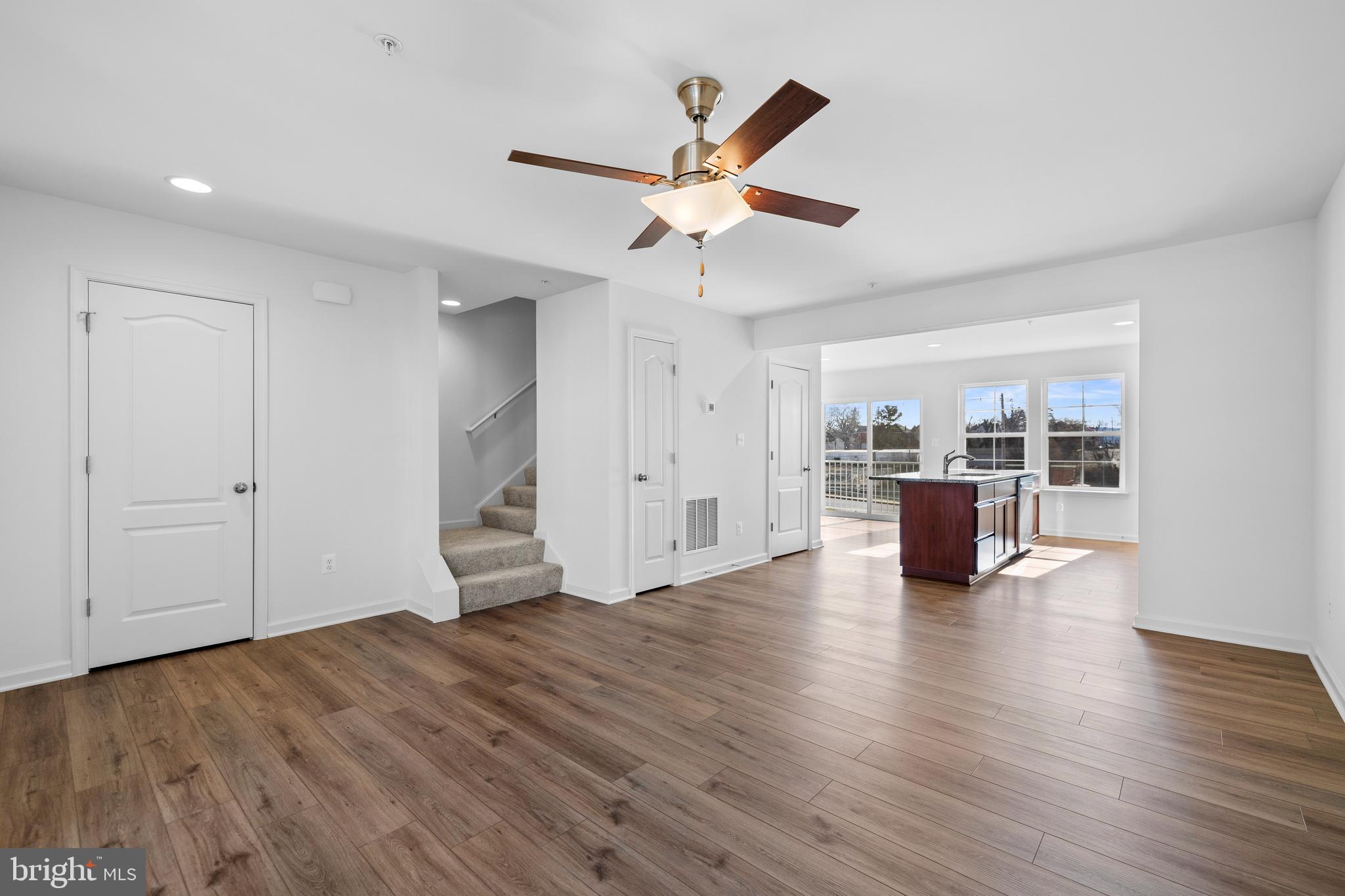444 Carrolton Avenue Hagerstown, MD 21740 - Photo 5 of 30 a view of an empty room with wooden floor and a ceiling fan