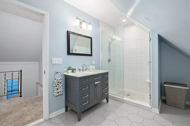 a bathroom with a granite countertop sink mirror and shower