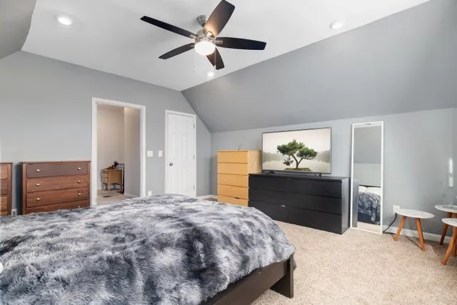 a bedroom with a bed and a dresser