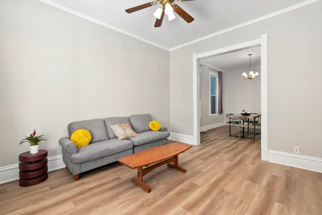 a living room with furniture and a chandelier
