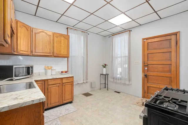 a kitchen that has a sink in it and wooden cabinets