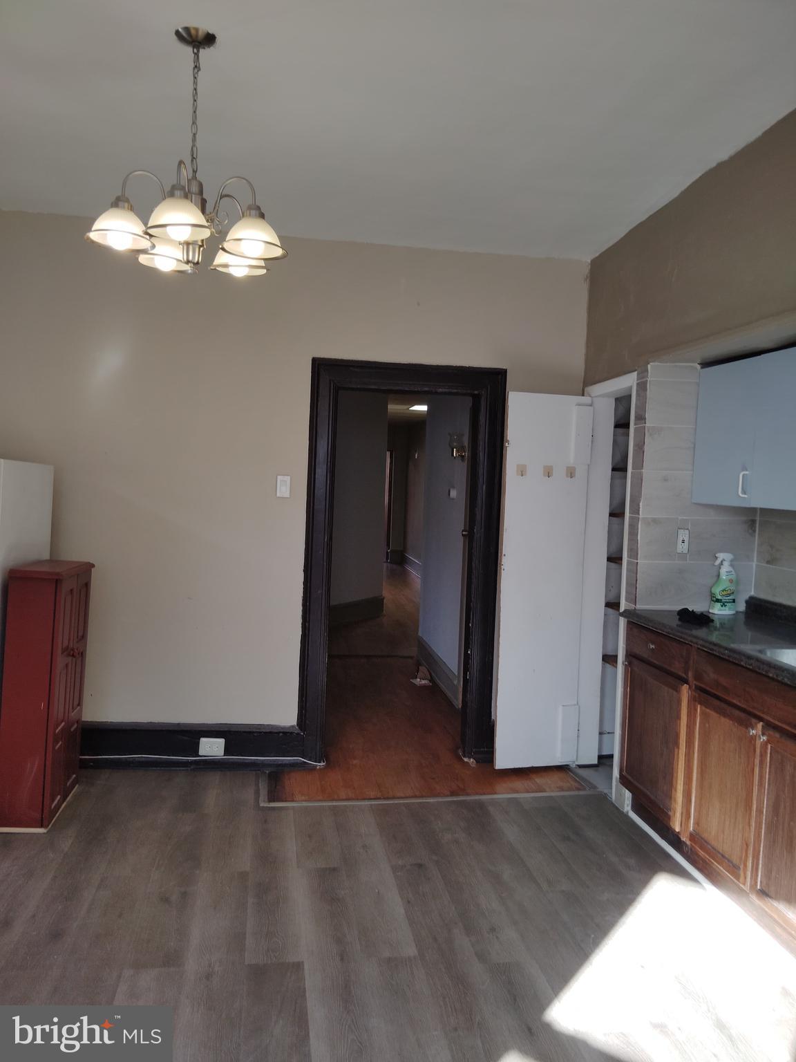 a view of a kitchen with a sink dishwasher and wooden floor