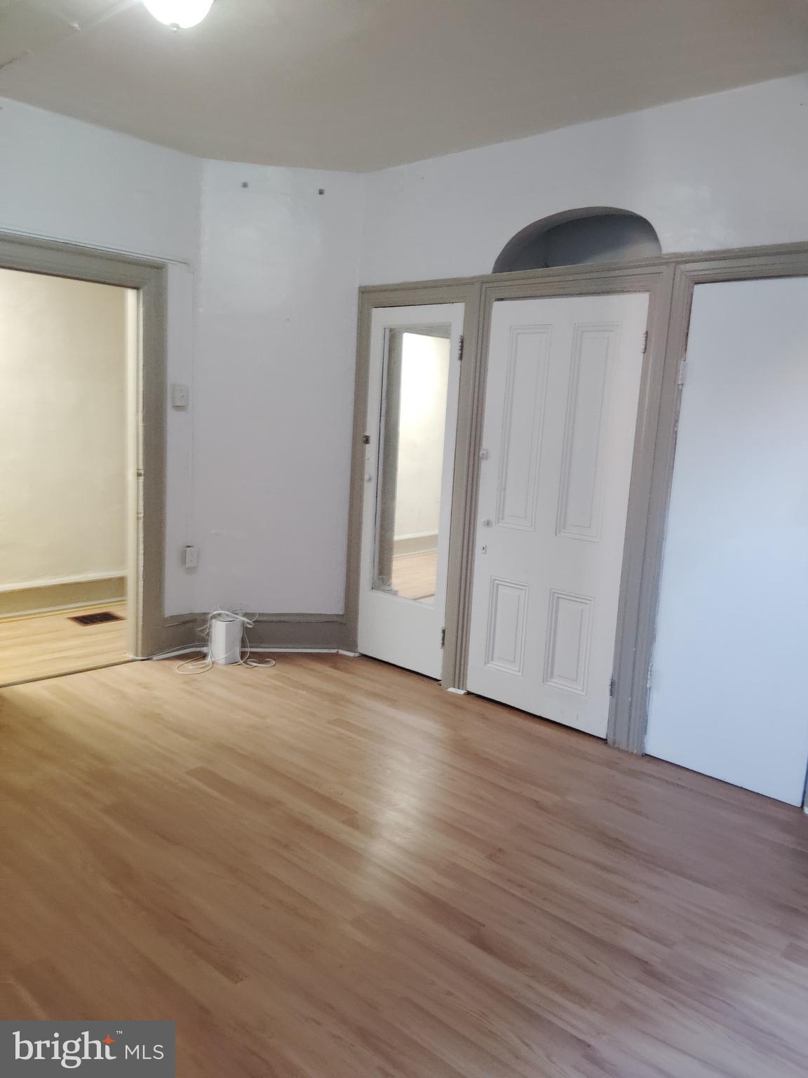 4514 Walnut Street Philadelphia, PA 19139 - Photo 4 of 10 a view of an empty room with wooden floor and a window