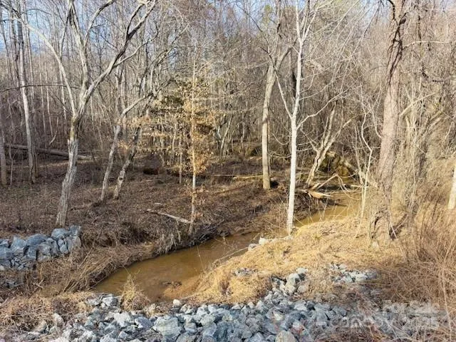 a view of wooden fence and trees