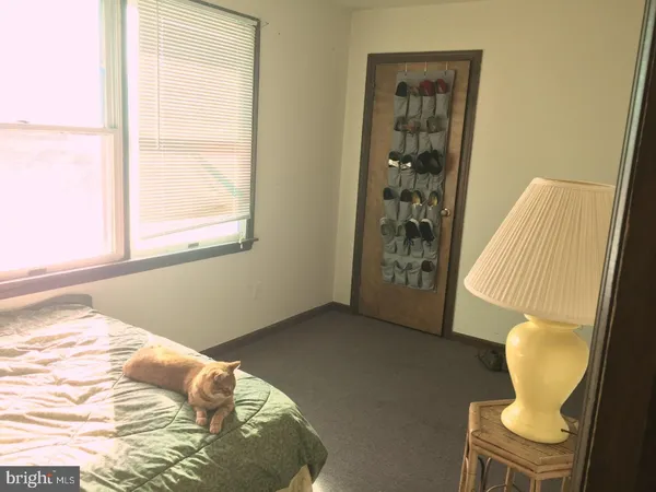 a bedroom with a bed and chair