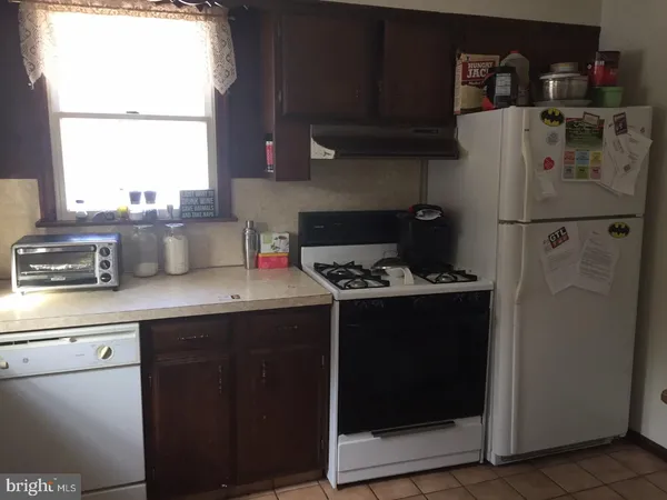 a kitchen with a stove and a refrigerator