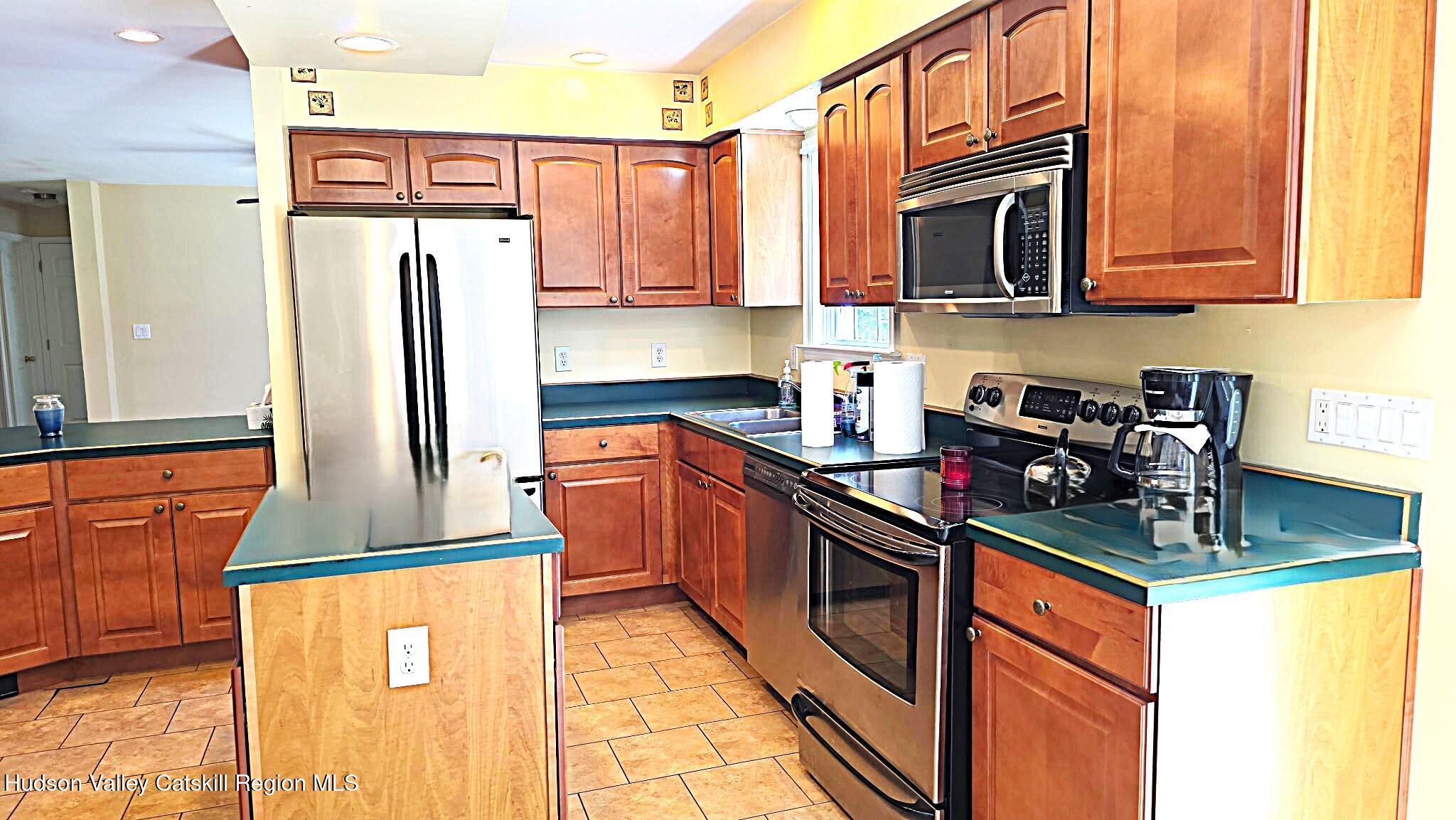 10 Lena Lane Cairo, NY 12413 - Photo 4 of 19 a kitchen with stainless steel appliances granite countertop a refrigerator and a stove top oven