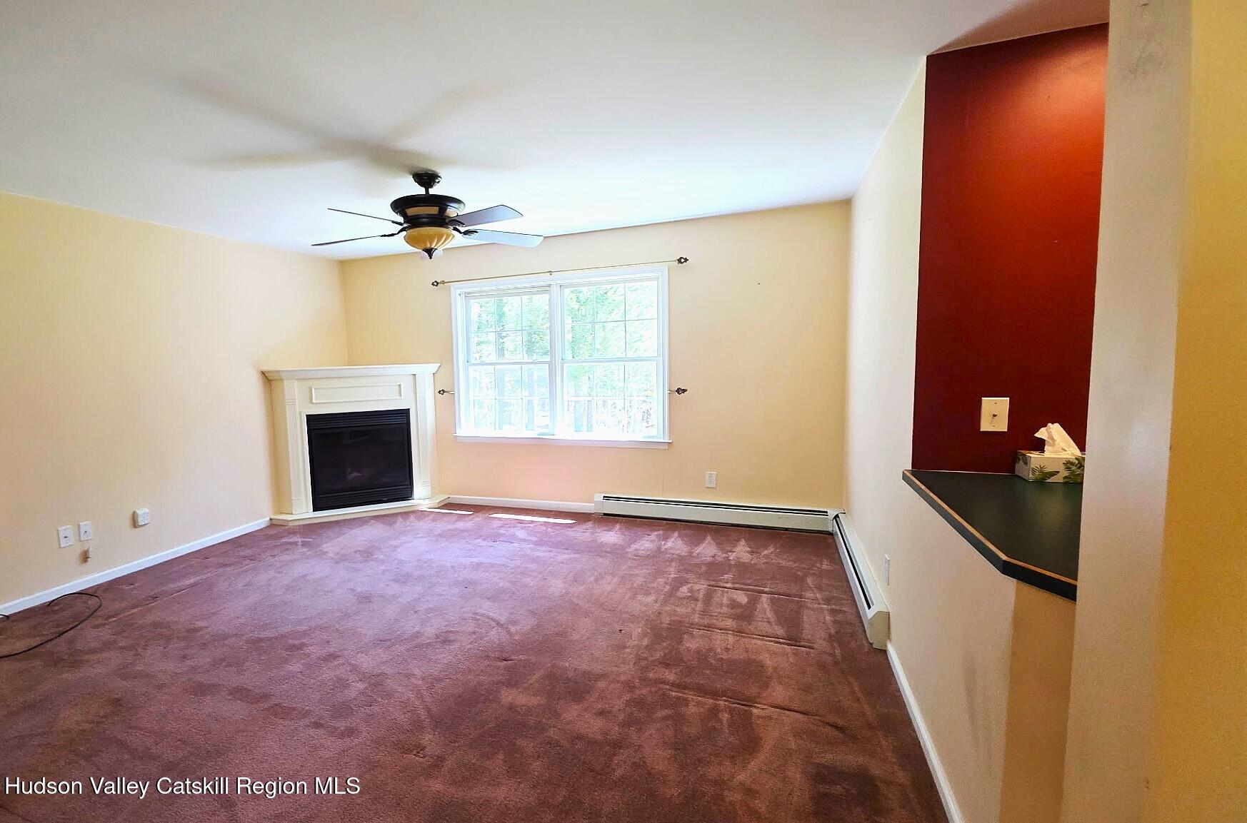 10 Lena Lane Cairo, NY 12413 - Photo 10 of 19 a view of an empty room with a fireplace and a window