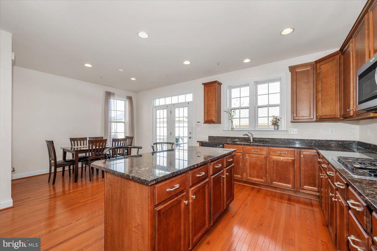 741 Appalachian Way Brunswick, MD 21716 - Photo 11 of 44 a kitchen with stainless steel appliances granite countertop sink stove top oven and cabinets