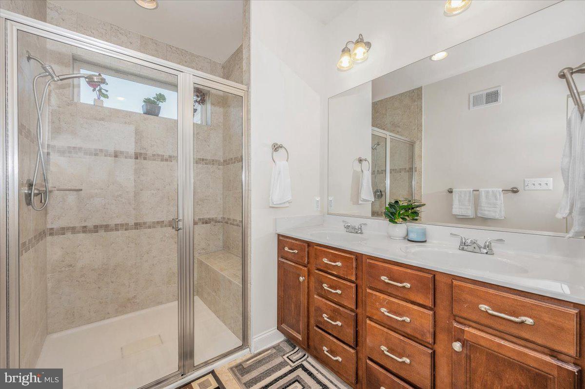 741 Appalachian Way Brunswick, MD 21716 - Photo 21 of 44 a bathroom with a shower sink and mirror