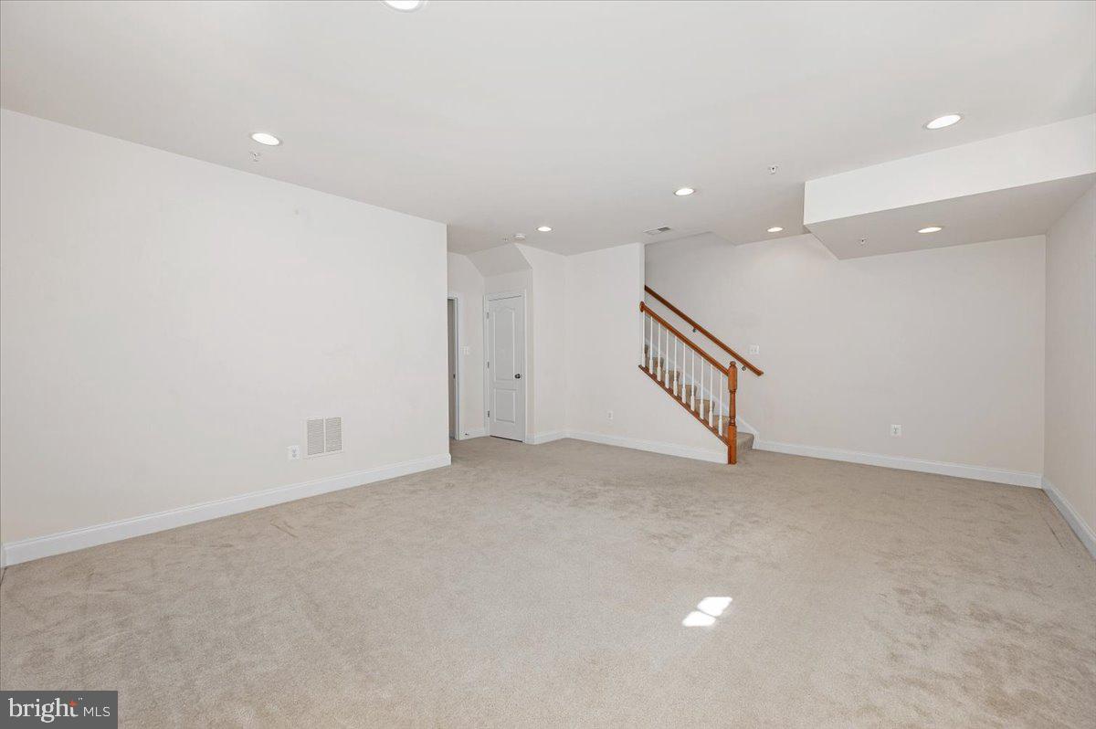 741 Appalachian Way Brunswick, MD 21716 - Photo 29 of 44 an empty room with a stairs and white walls