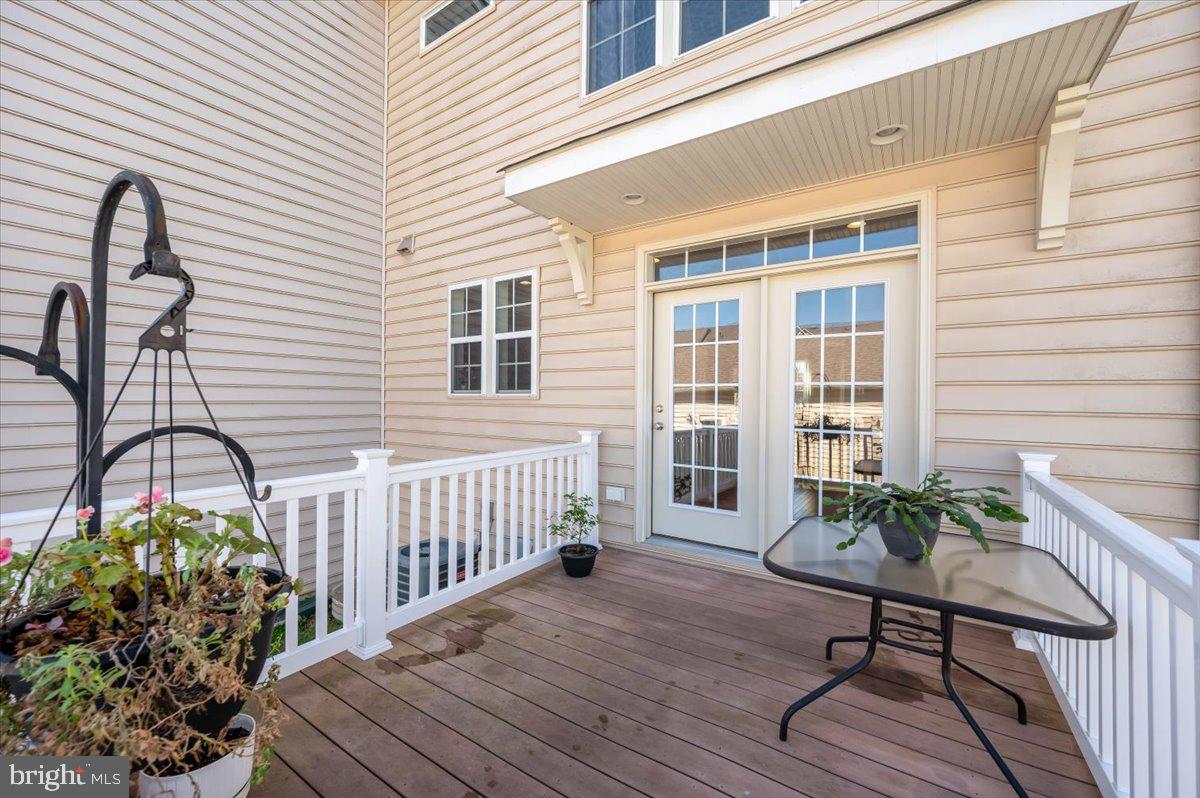 741 Appalachian Way Brunswick, MD 21716 - Photo 35 of 44 a balcony with wooden floor table and chairs