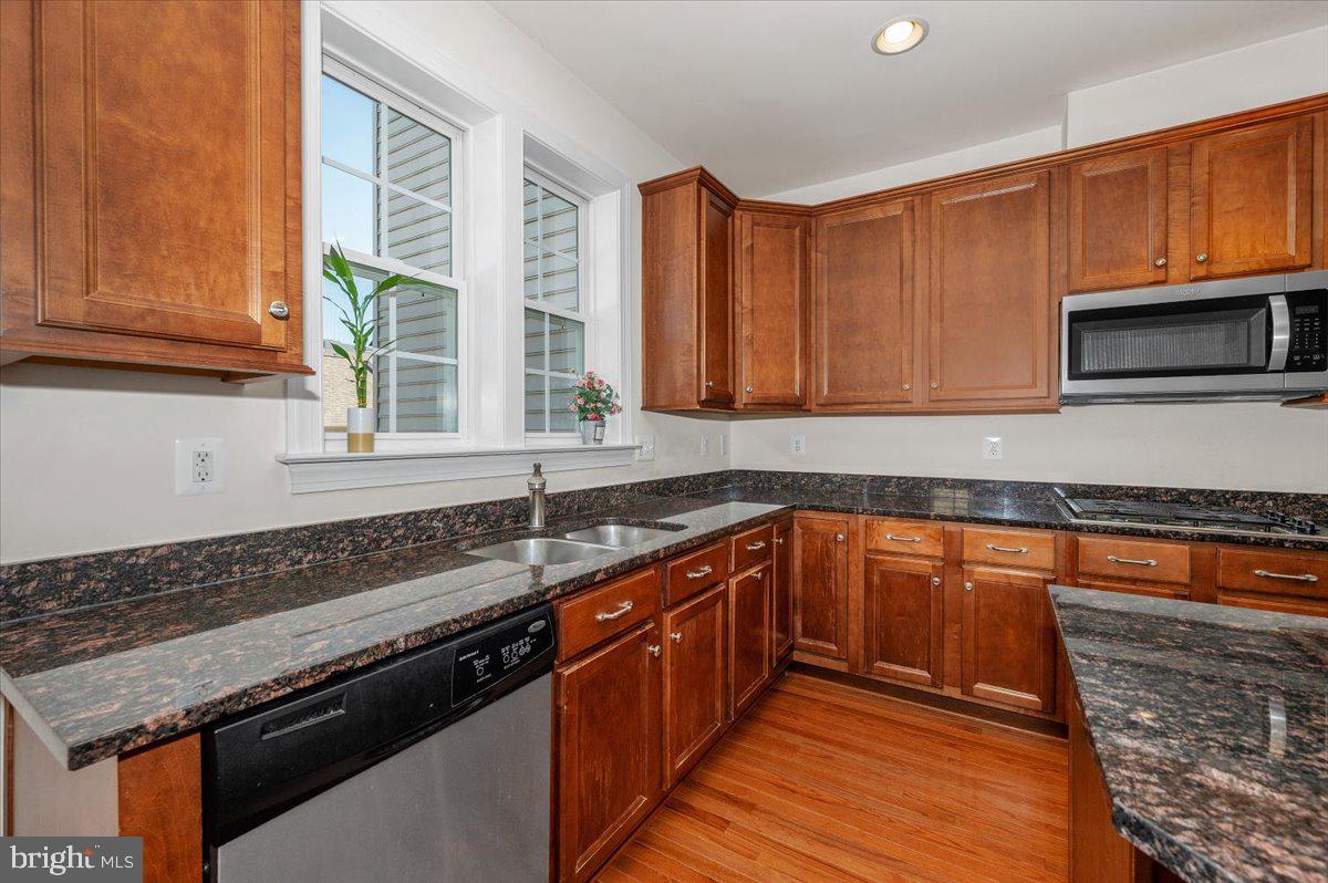 741 Appalachian Way Brunswick, MD 21716 - Photo 10 of 44 a kitchen with stainless steel appliances granite countertop a stove a sink and a microwave