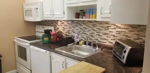 a kitchen with a sink and cabinets