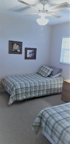 a bedroom with bed and a window