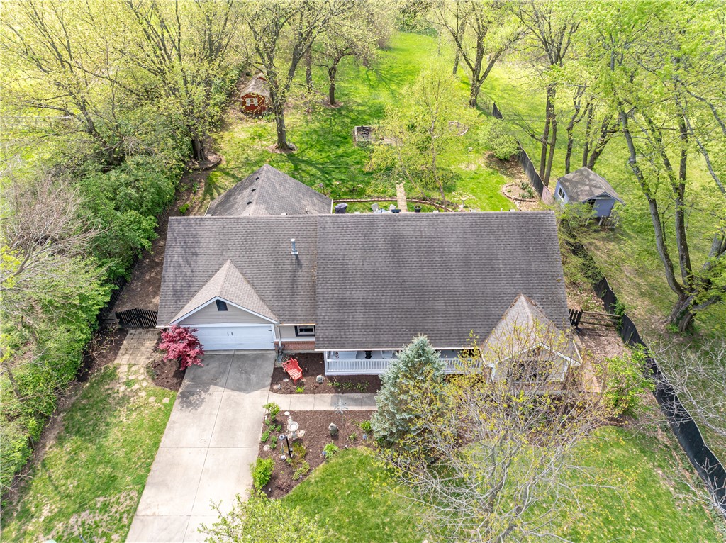 159 East Lytle 5 Points Road Springboro, OH 45066 - Photo 45 of 45 An aerial view captures a home nestled among lush trees, featuring a welcoming porch and driveway.