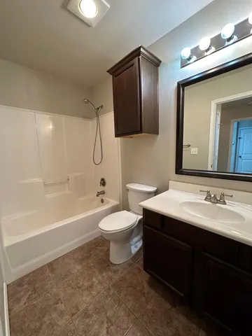 an empty room with a ceiling fan and window