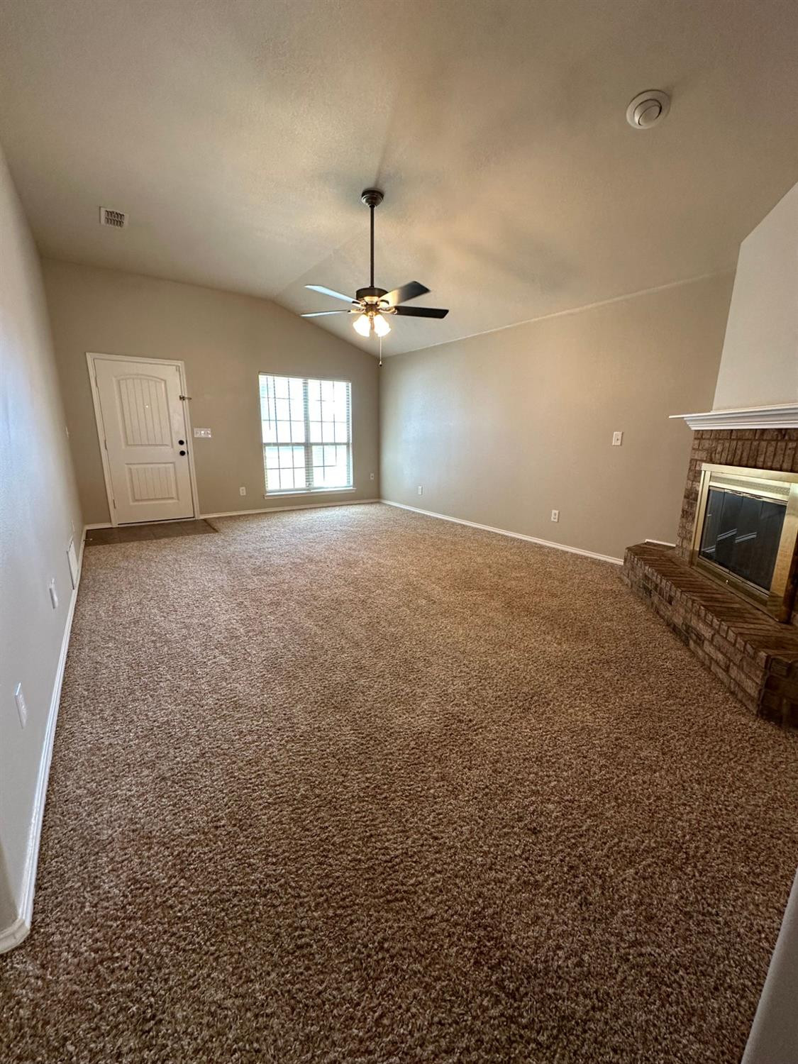 9316 Rochester Avenue Lubbock, TX 79424 - Photo 15 of 15 an empty room with a ceiling fan and window