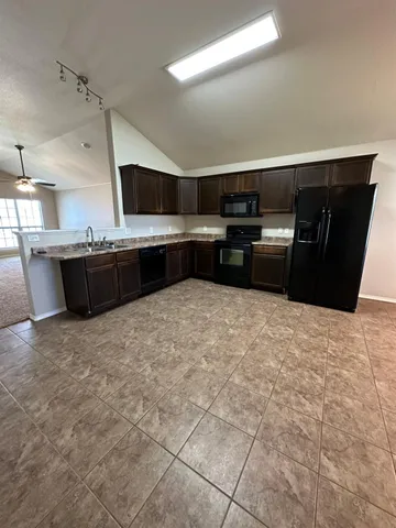 a kitchen with a stove and a refrigerator