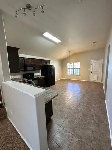 a kitchen with a stove and a refrigerator