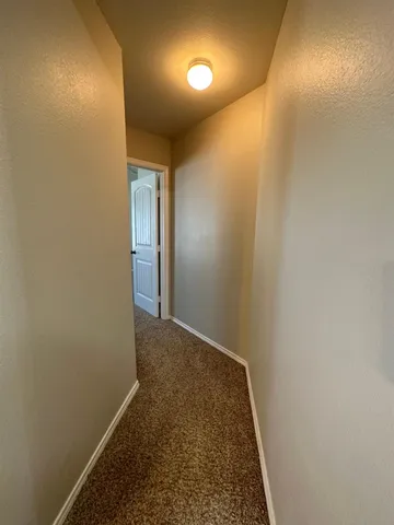 an empty room with windows and ceiling fan view