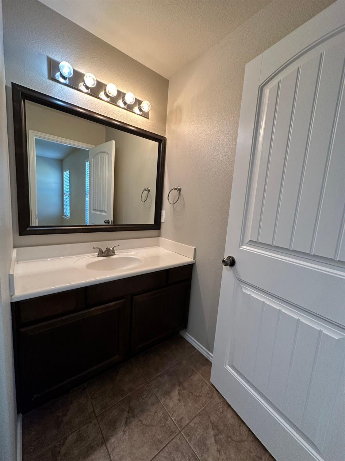 9316 Rochester Avenue Lubbock, TX 79424 - Photo 8 of 15 a bathroom with a sink and a mirror