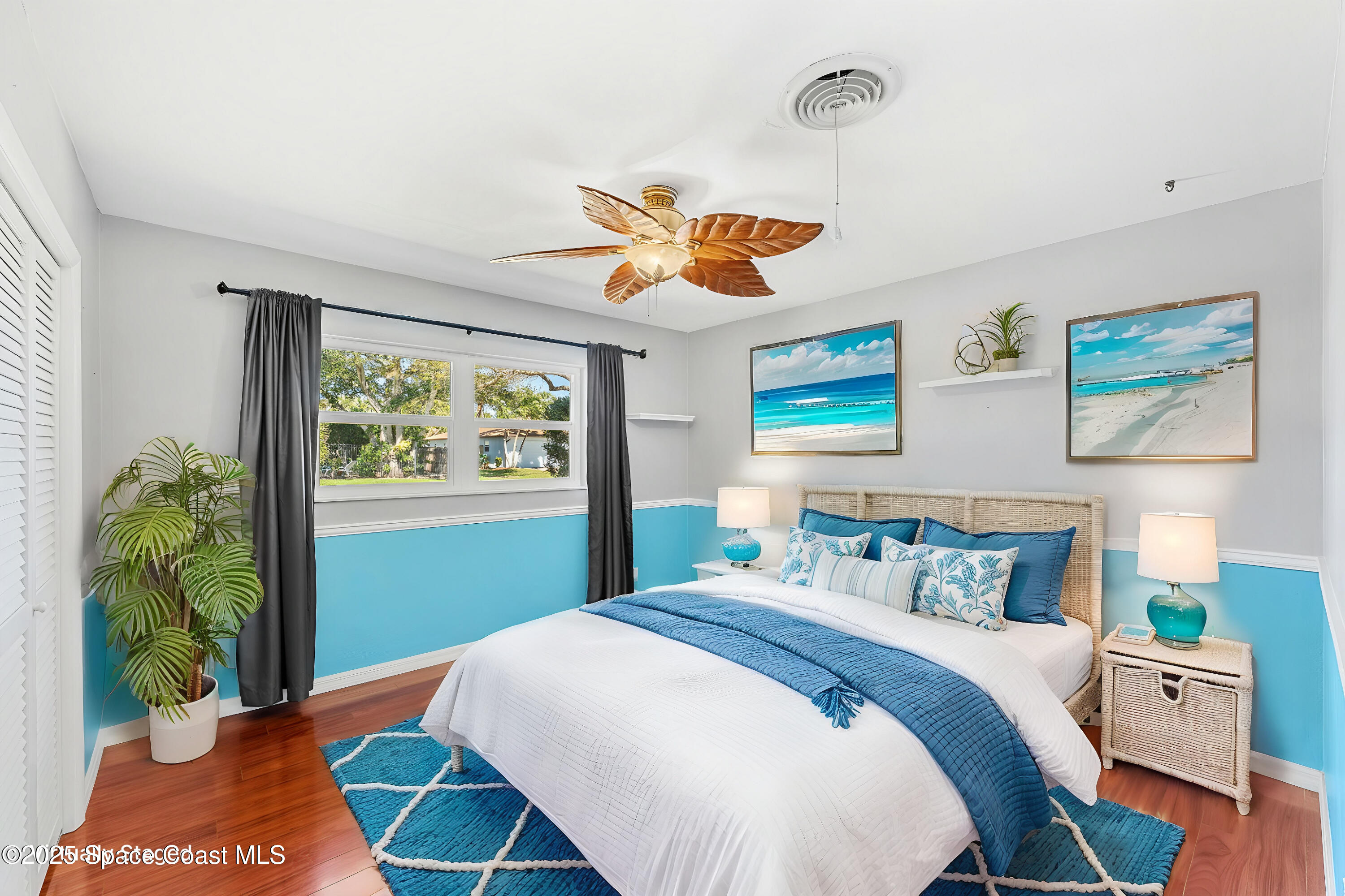 157 Cocoa Avenue Indialantic, FL 32903 - Photo 18 of 36 a bedroom with a bed and a chandelier