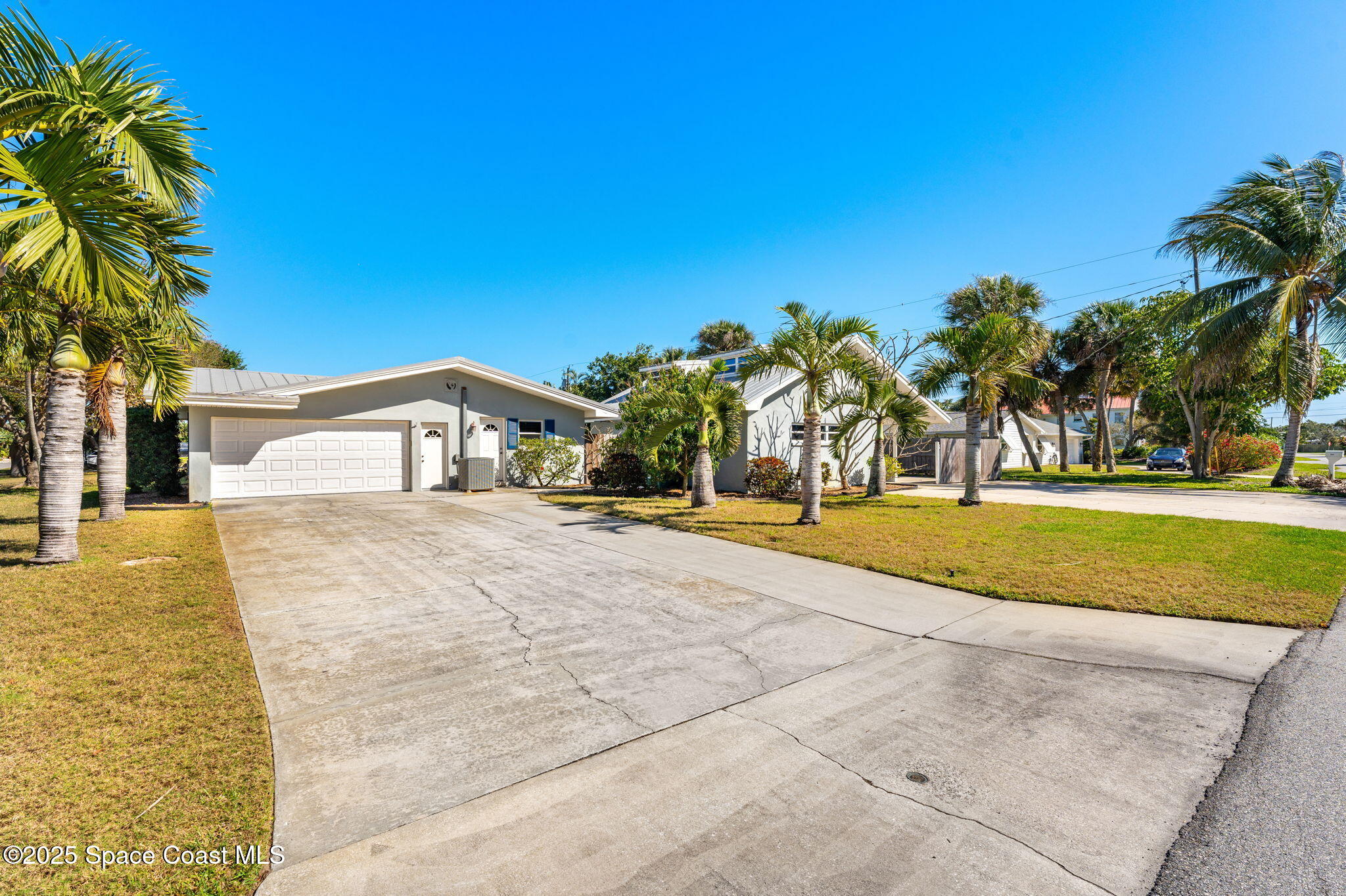 157 Cocoa Avenue Indialantic, FL 32903 - Photo 30 of 36 a house with trees in front of it