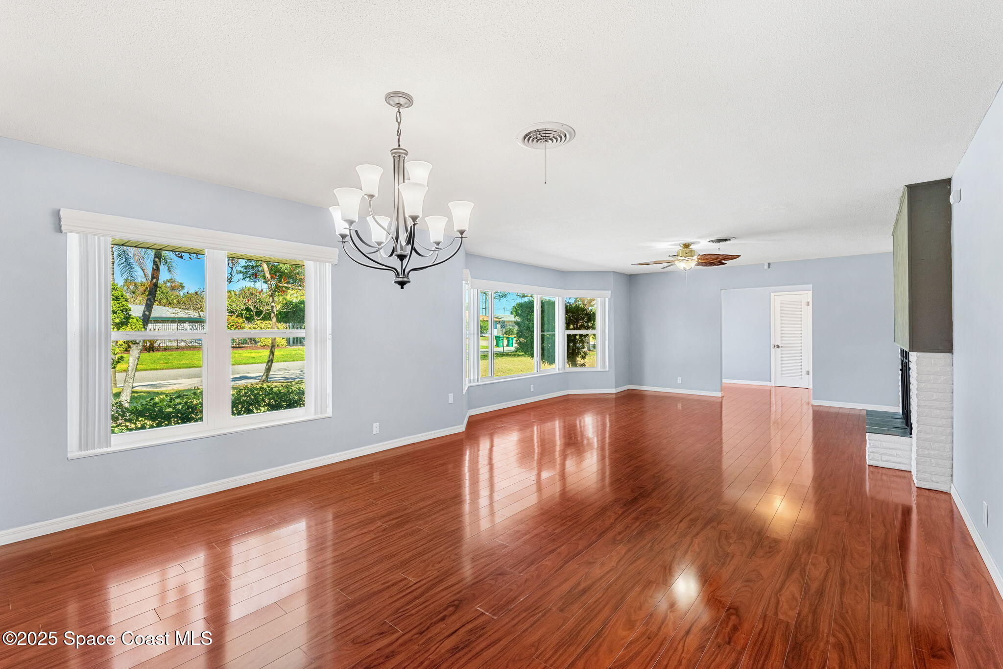 157 Cocoa Avenue Indialantic, FL 32903 - Photo 5 of 36 a view of empty room with wooden floor and large window