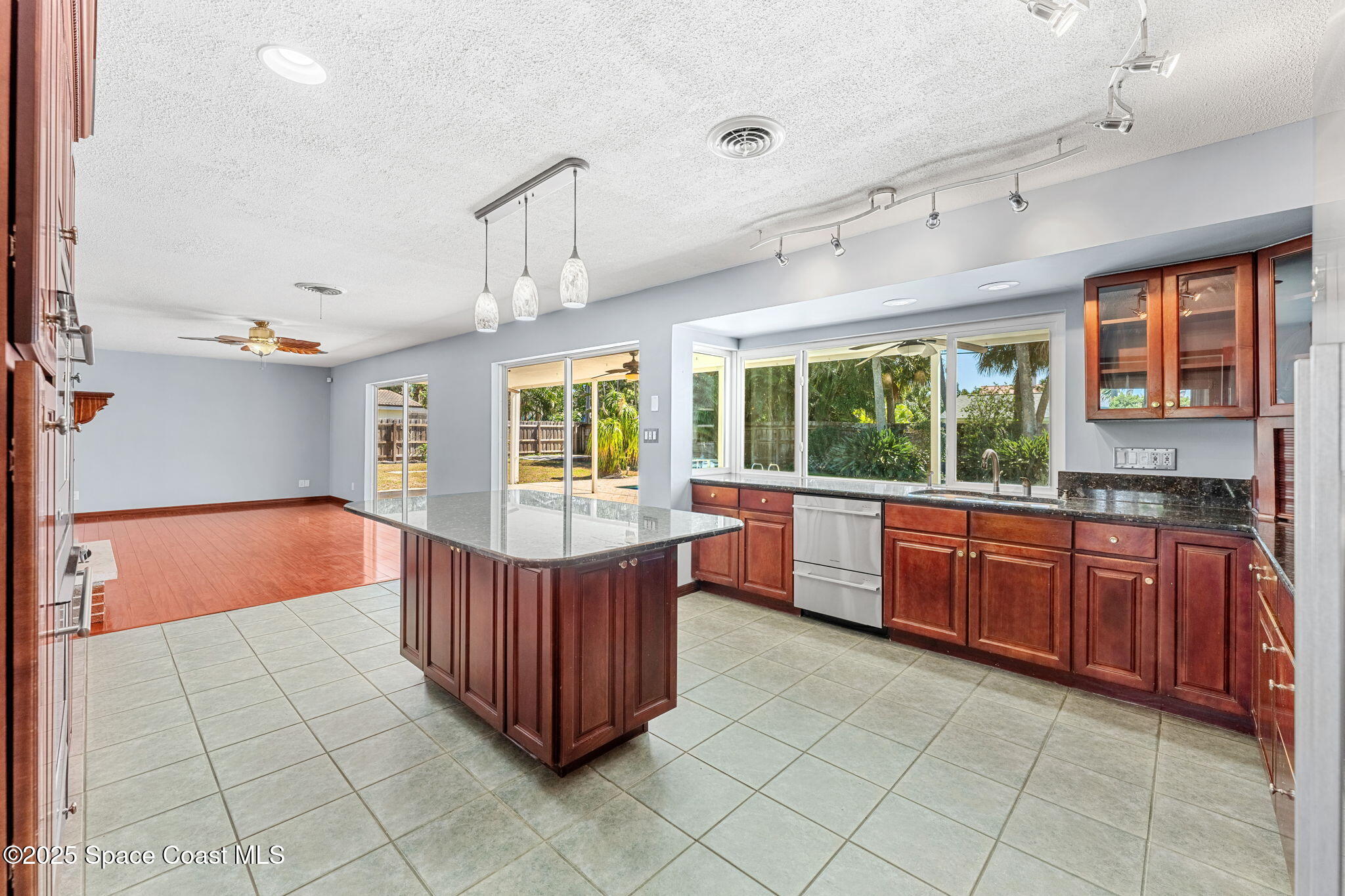 157 Cocoa Avenue Indialantic, FL 32903 - Photo 10 of 36 a kitchen with stainless steel appliances granite countertop a stove a sink dishwasher and cabinets