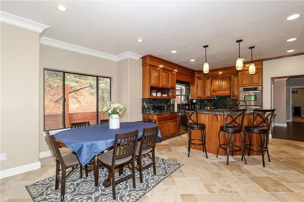 a kitchen with stainless steel appliances granite countertop a stove a sink and a refrigerator