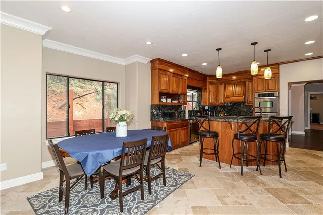 a kitchen with stainless steel appliances granite countertop a stove a sink and a refrigerator