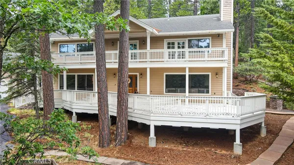a view of house with a yard and sitting area