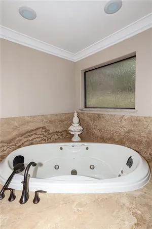 a view of a house with a wooden deck and a yard