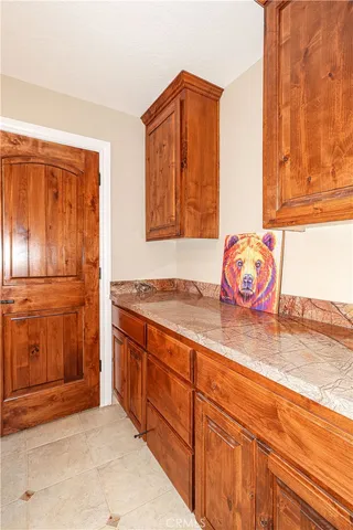 a view of a house with a small yard and wooden fence