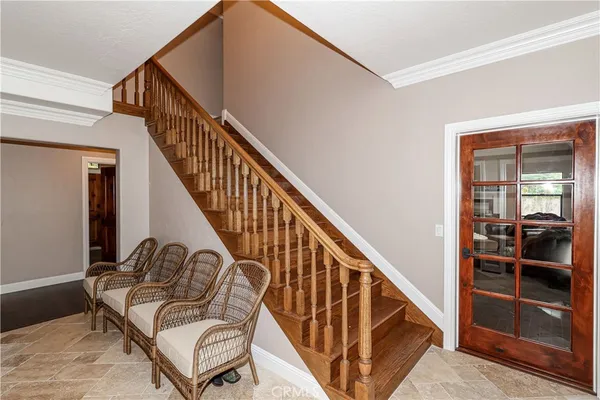 a dining room with furniture and a floor to ceiling window