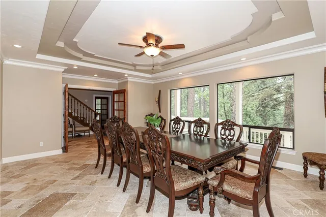 a dining hall with stainless steel appliances granite countertop a stove and a dining table