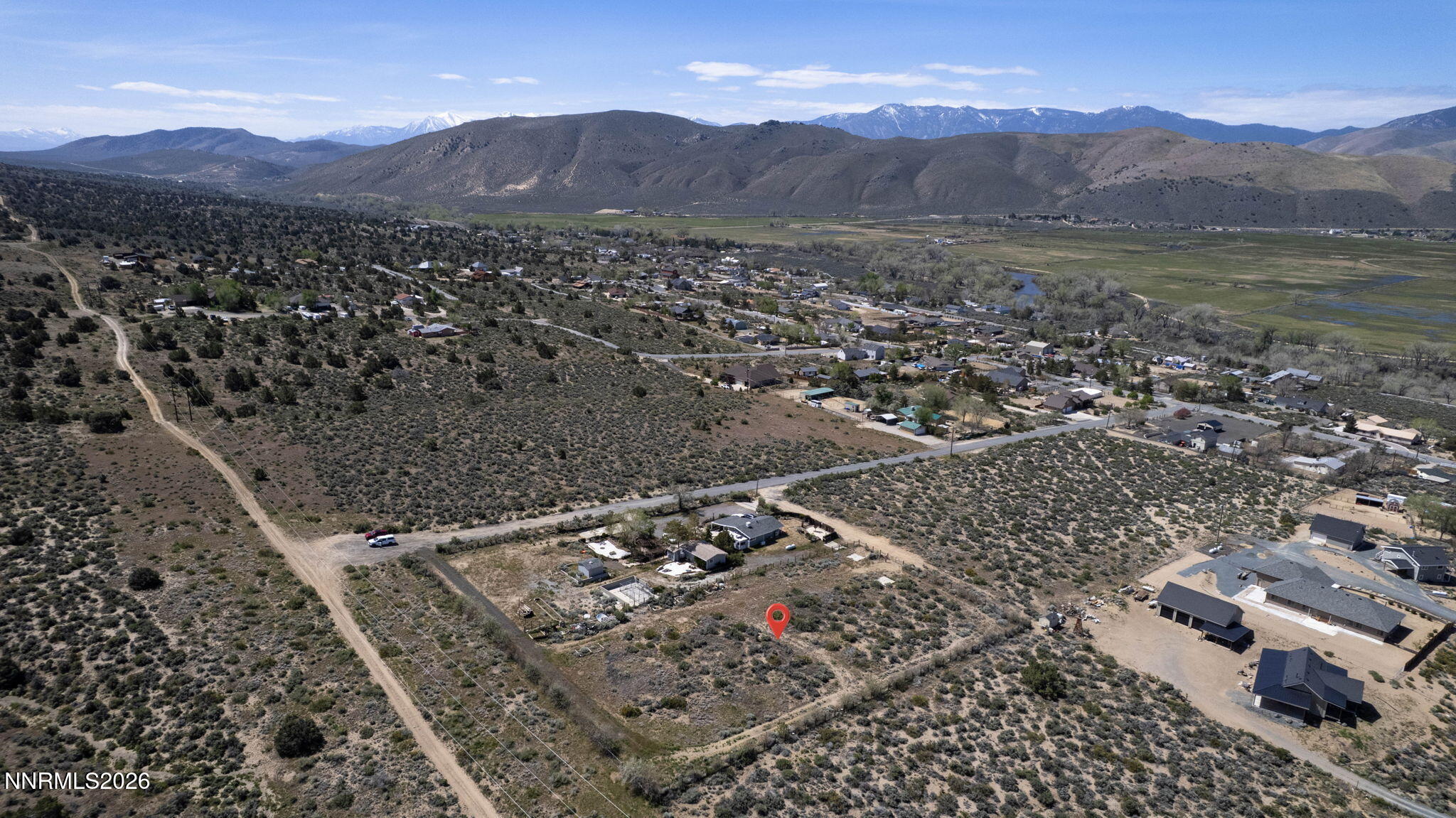 6260 Pursia Road Carson City, NV 89701 - Photo 17 of 26 a view of a lush green hillside and a building