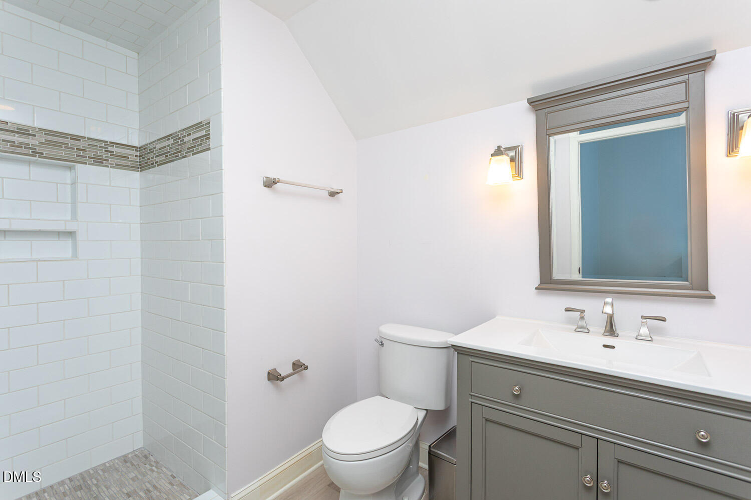 8509 Towneley Place Raleigh, NC 27615 - Photo 29 of 36 a bathroom with a sink a toilet and a mirror